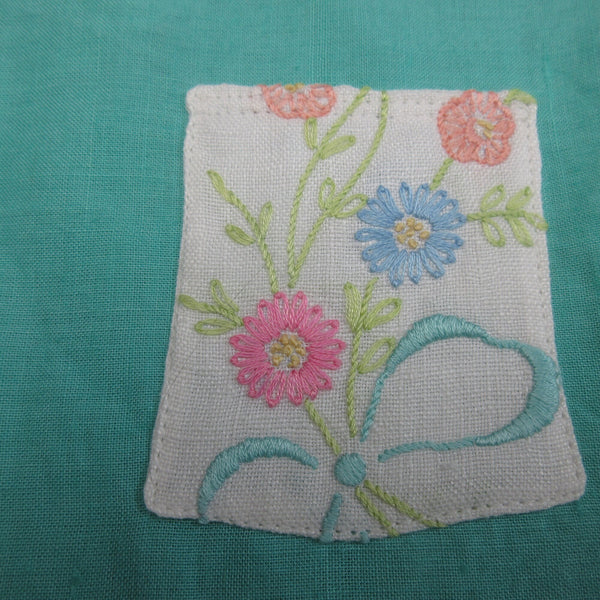 Child's vintage turquoise linen top with a pocket of beautifully embroidered flowers in pink, blue and peach, size 18 months