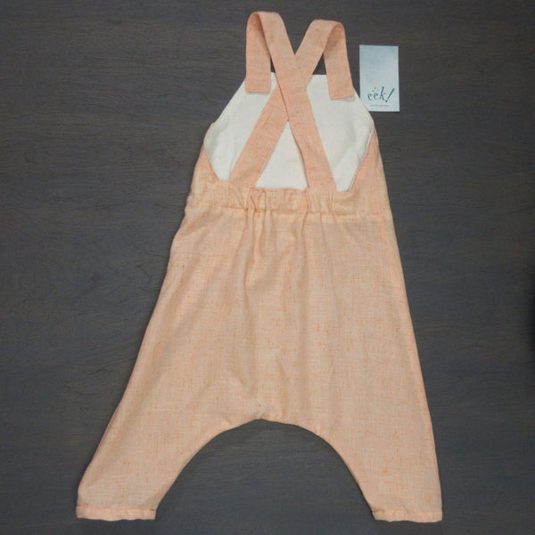 Child's peach reclaimed linen romper overalls with an embroidered and appliqued front pocket, size 2