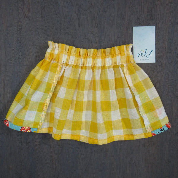 Child's vintage yellow gingham linen and cotton skirt with turquoise, red, yellow and black patterned pockets, size 3