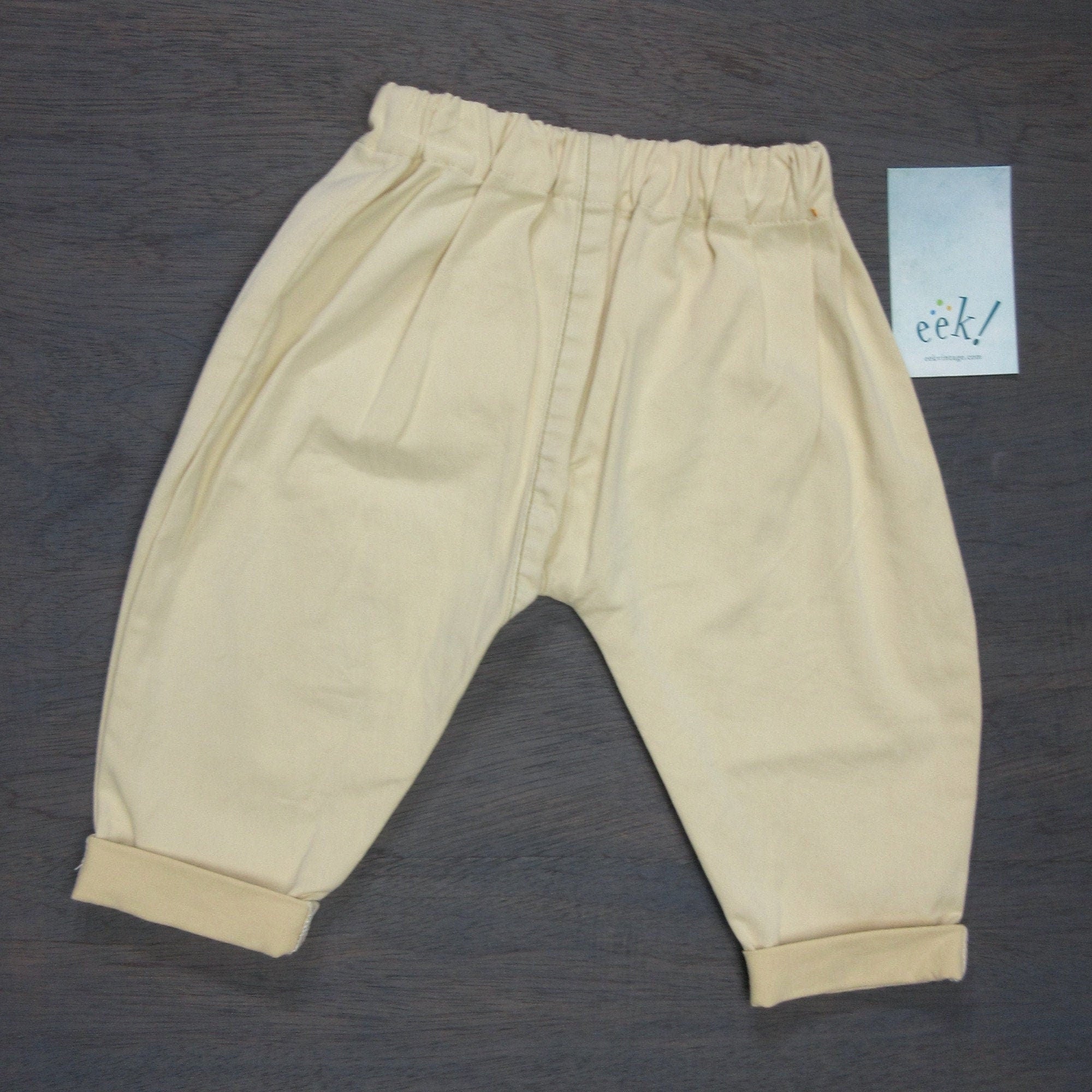 Beachcomber pants in cream khaki with vintage pink pocket on back, elastic waist, cuffed legs, size 6 months